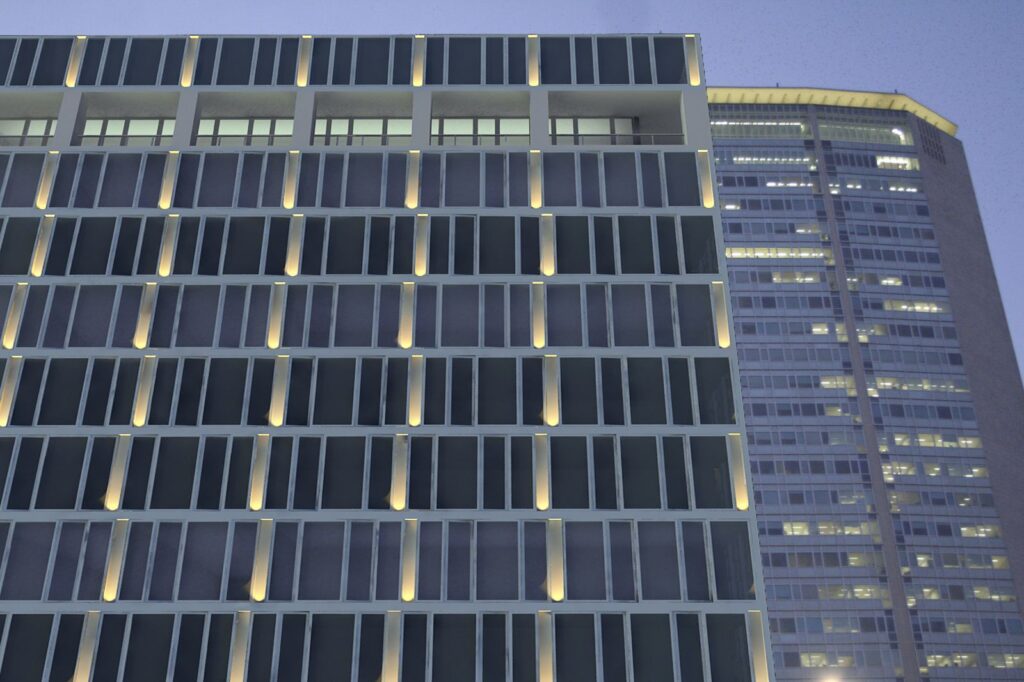 Urban 3D rendering of the Office Building - Stazione Centrale Milan at night with the outside lights illuminating