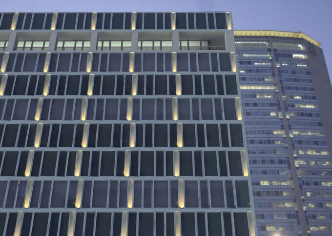 Urban 3D rendering of the Office Building - Stazione Centrale Milan at night with the outside lights illuminating