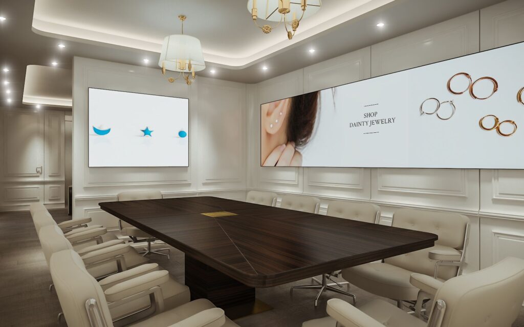 Commercial 3D rendering of the J&CO Headquarter office designed with large screens on the walls, a wooden table in the center of the room, and cream-colored leather chairs