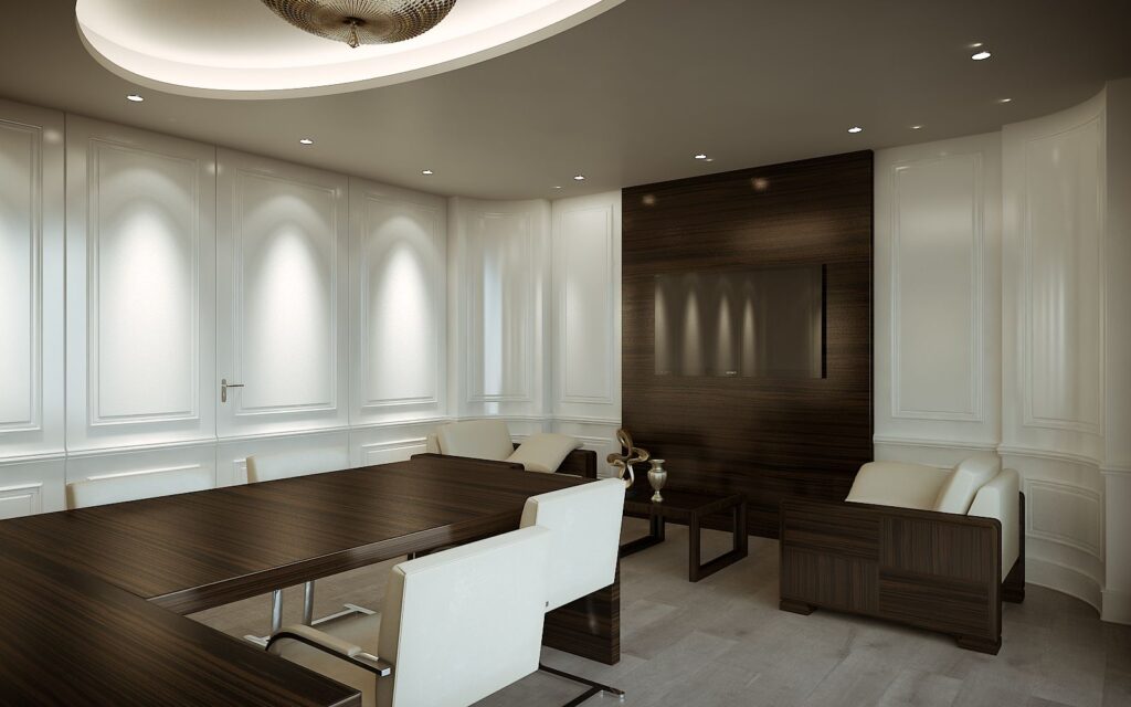 3D-Innenansicht des J&CO-Hauptsitzes mit einem Pausenbereich, der mit zwei cremefarbenen Ledersesseln und weißen Wänden gestaltet ist