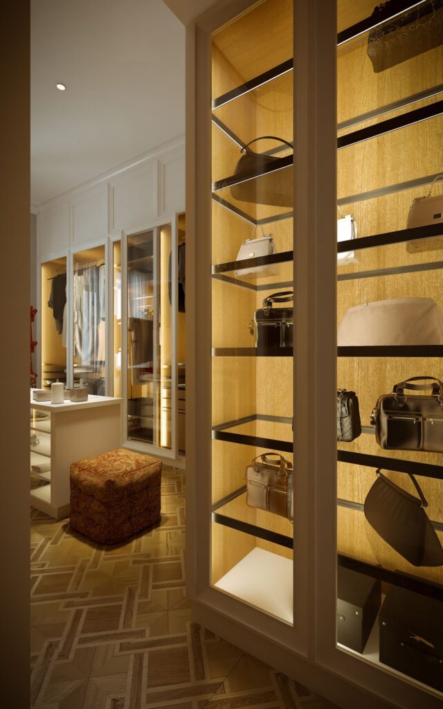 Residential 3D rendering of the Milan apartment dressing room with closets that have glass doors, interior light, and hardwood floors